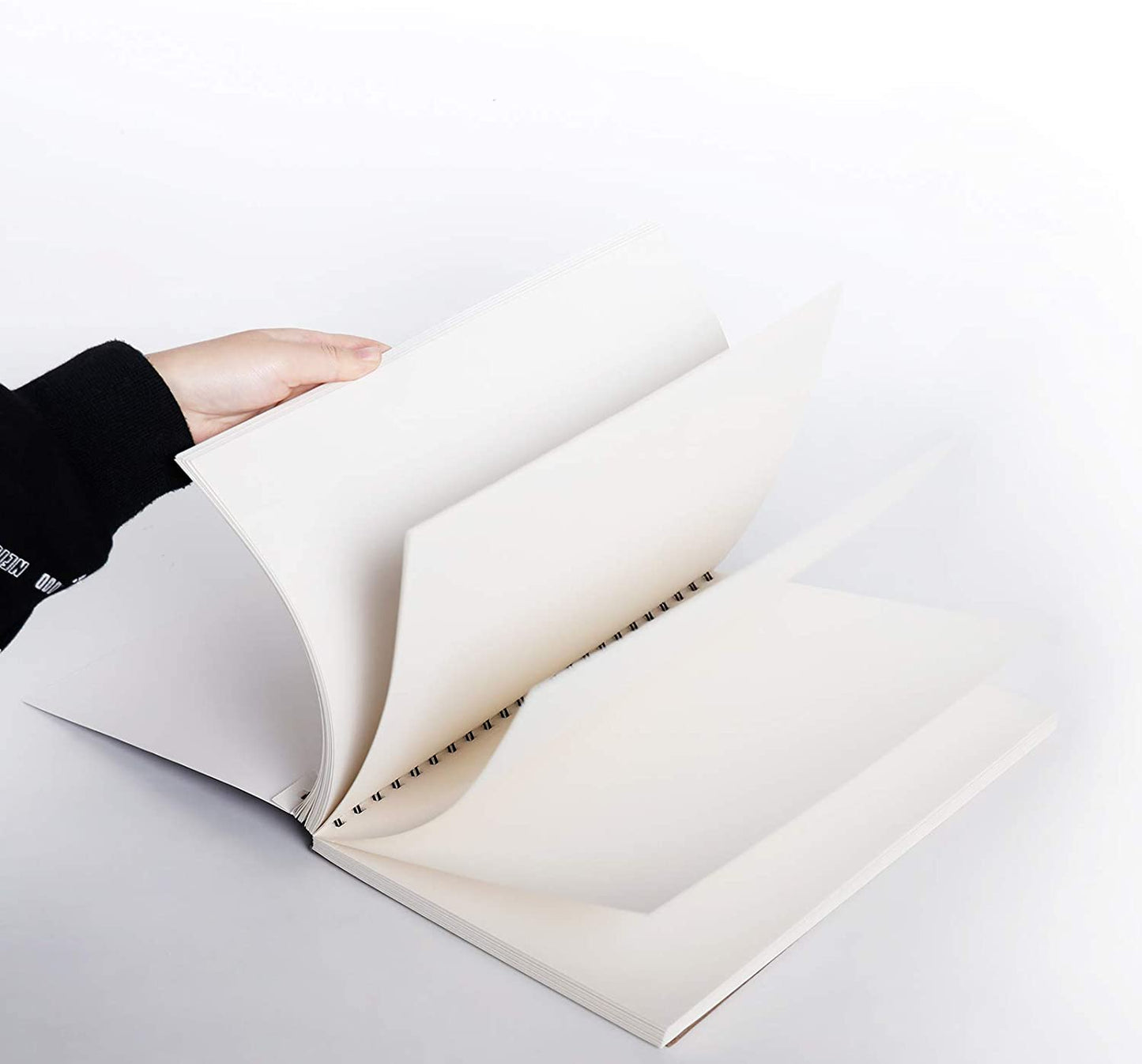 A person flicking through the TBC sketch book that has 100 sheets, which are 9 x 12" - Stationery Island