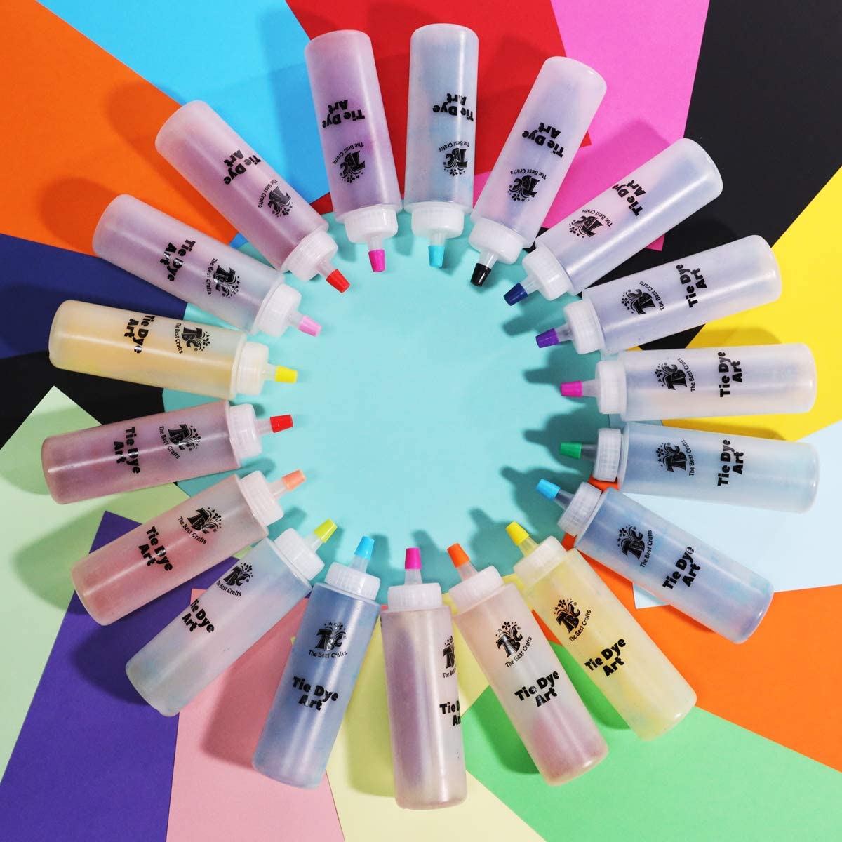 18 bottles with coloured dye inside placed together in a circle - Stationery Island