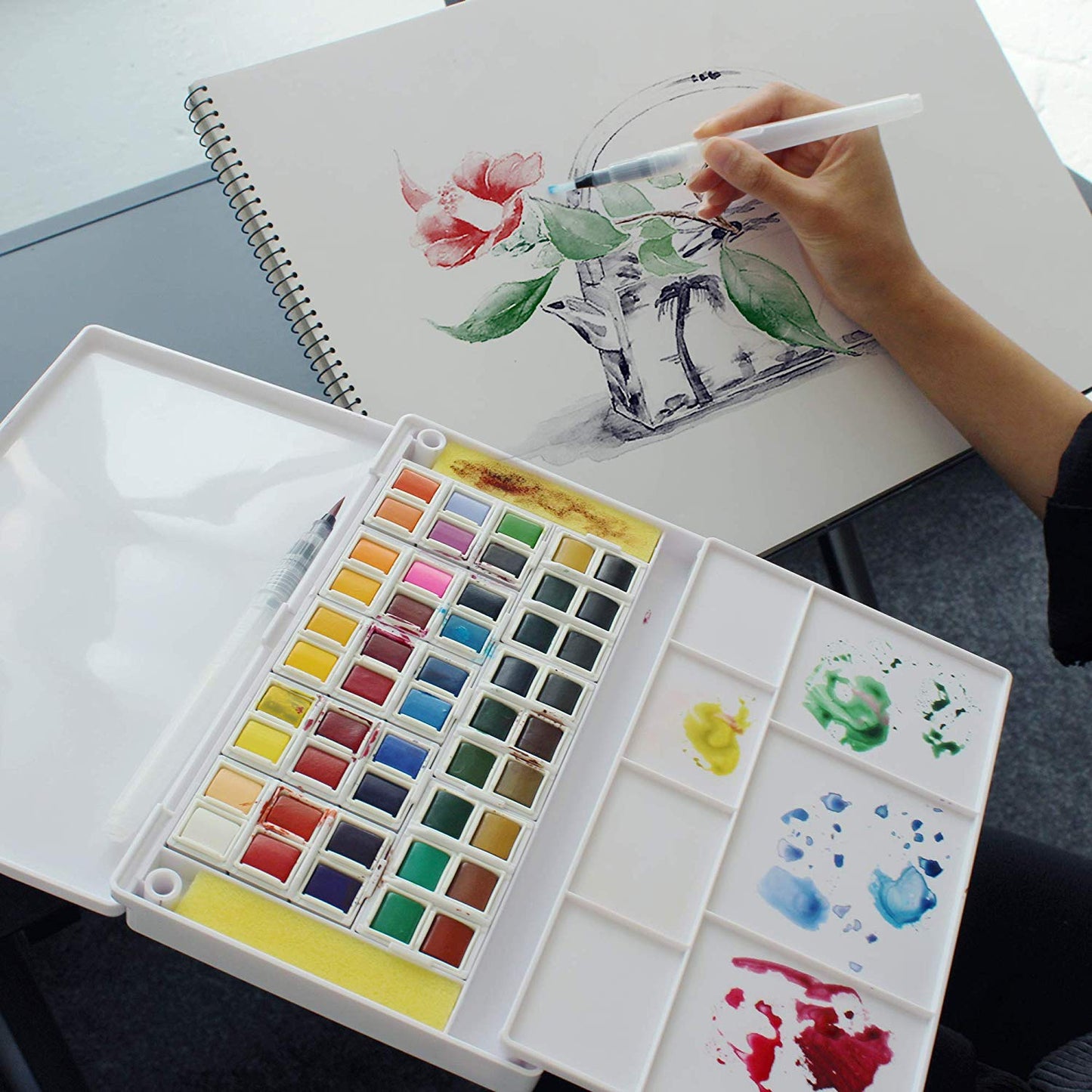 Colours from the Ezigoo watercolour paint set that has 48 colours and an aqua brush, used to paint a picture - Stationery Island